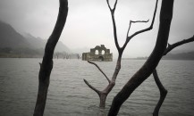 The remains of a mid-16th century church known as the Temple of Santiago, as well as the Temple of Quechula, is visible from the surface of the Grijalva River, which feeds the Nezahualcoyotl reservoir, due to the lack of rain near the town of Nueva Quechula, in Chiapas state, Mexico, Friday, Oct. 16, 2015. The temple, built by Dominican friars in the region inhabited by the Zoque people, was submerged in 1966 when the Nezahualcoyotl dam was built. (AP Photo/David von Blohn)